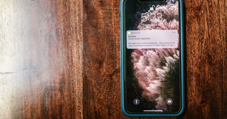 Celular con una alerta de fraude en la pantalla de bloqueo