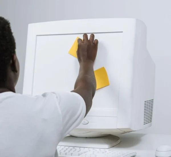 Persona frente a una computadora de escritorio antigua con monitor de cinescopio